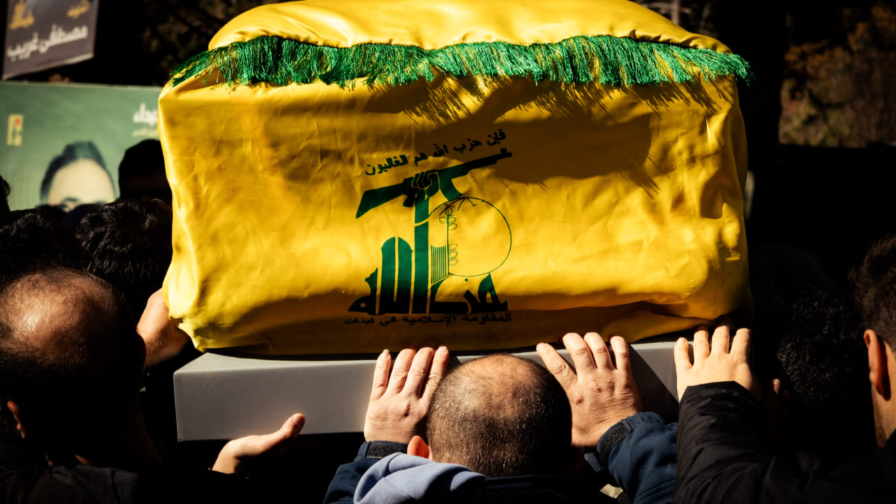 Pallbearers carry a coffin