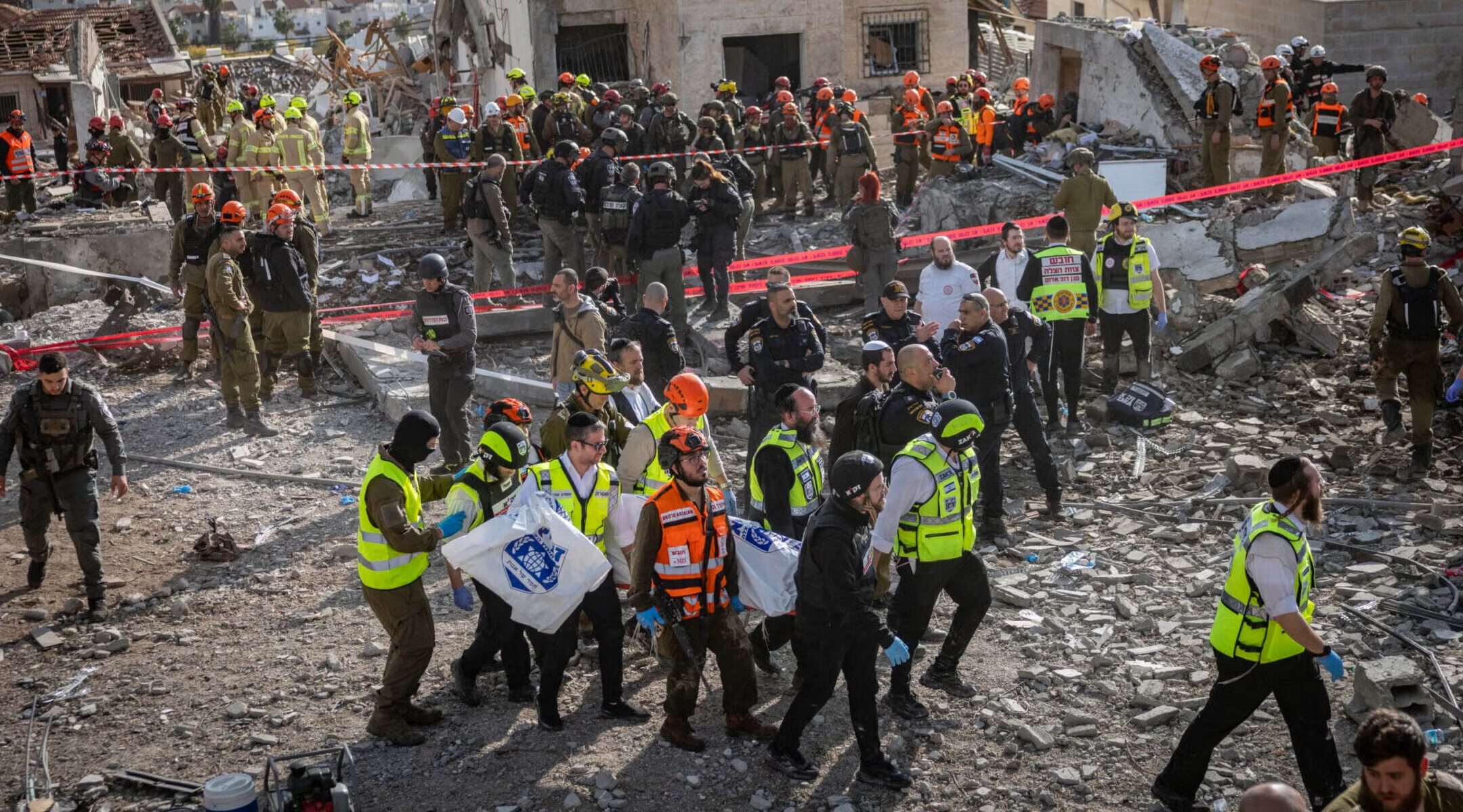 Israeli security and rescue forces operate at the scene where a ballistic missile fired from Iran struck Beit Shemesh, central Israel, causing extensive destruction and killing at least nine people, March 1, 2026. (Yonatan Sindel/Flash90)
