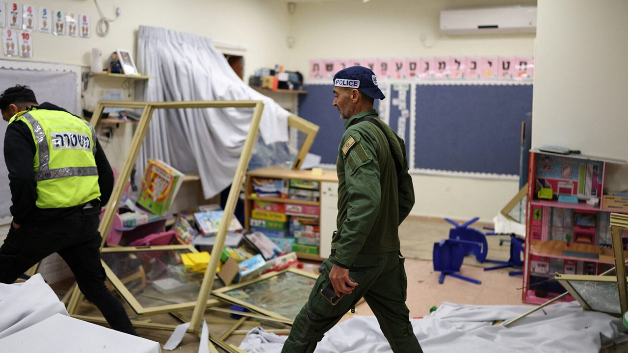 Israeli police examine the scene after a strike hit a kindergarten in the central Israeli city of Ramla on March 9, 2026. (Ilia Yefimovich / AFP via Getty Images)