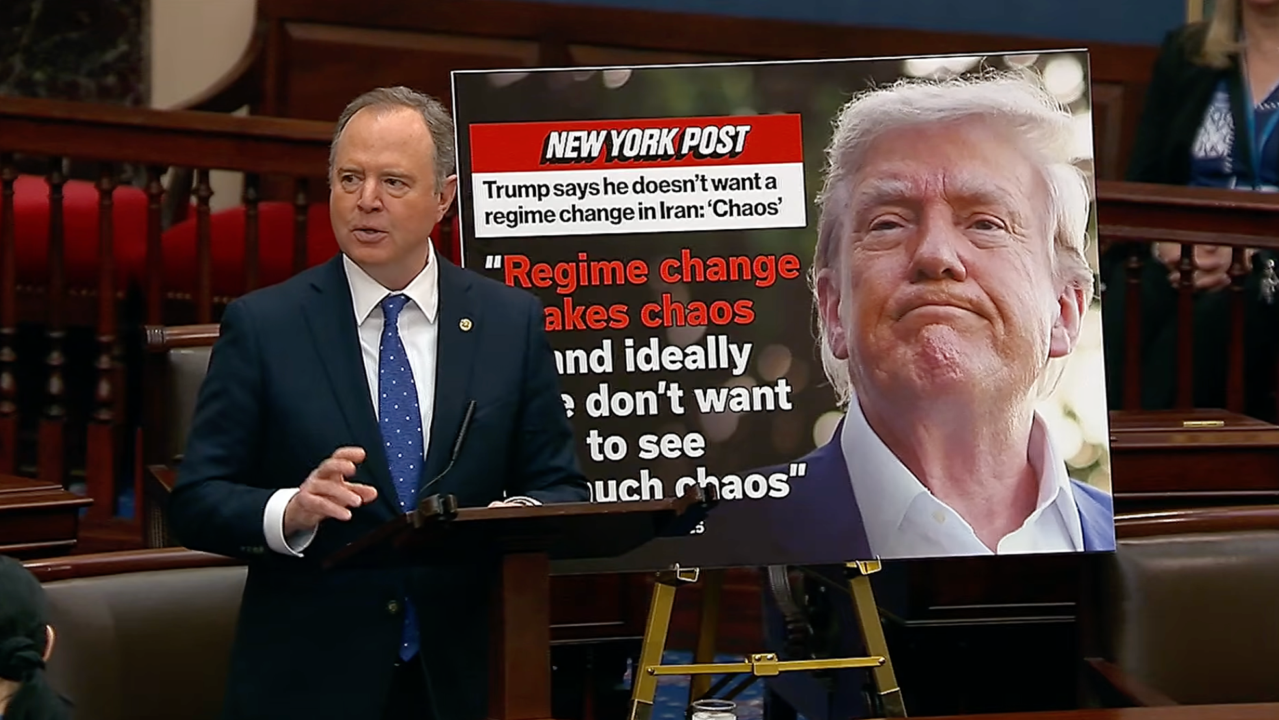 Adam Schiff in blue tie speaks in Senate next to image of Donald Trump