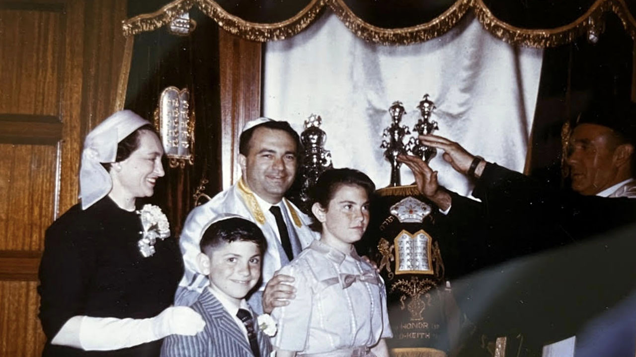 Judy Stein and family stand before the ark in 1957, with Rabbi Saul E. White. (Courtesy)