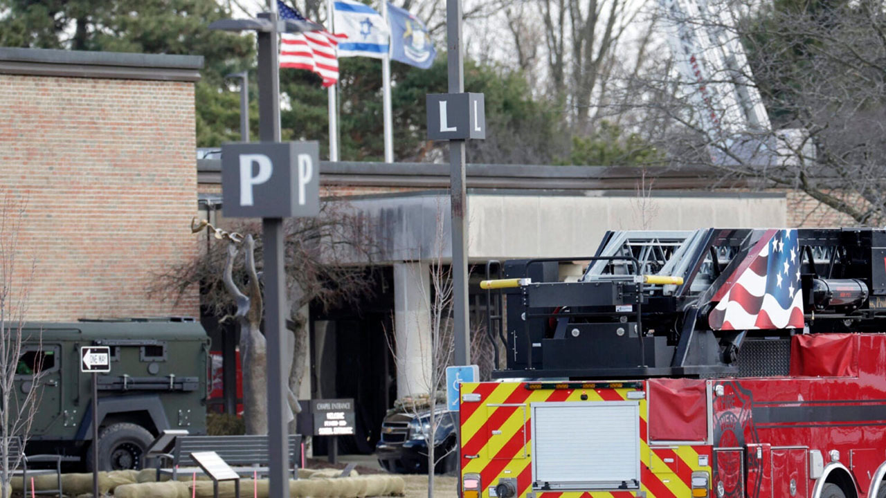 Law enforcement remain on site at the Temple Israel synagogue in West Bloomfield, Michigan, a Detroit suburb, on March 12, 2026, after an assailant drove a vehicle into the building. (Photo by Jeff Kowalsky/AFP via Getty Images)