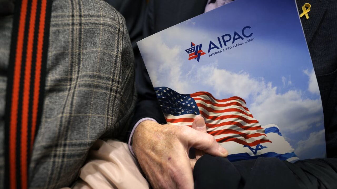 visitor holds an AIPAC folder