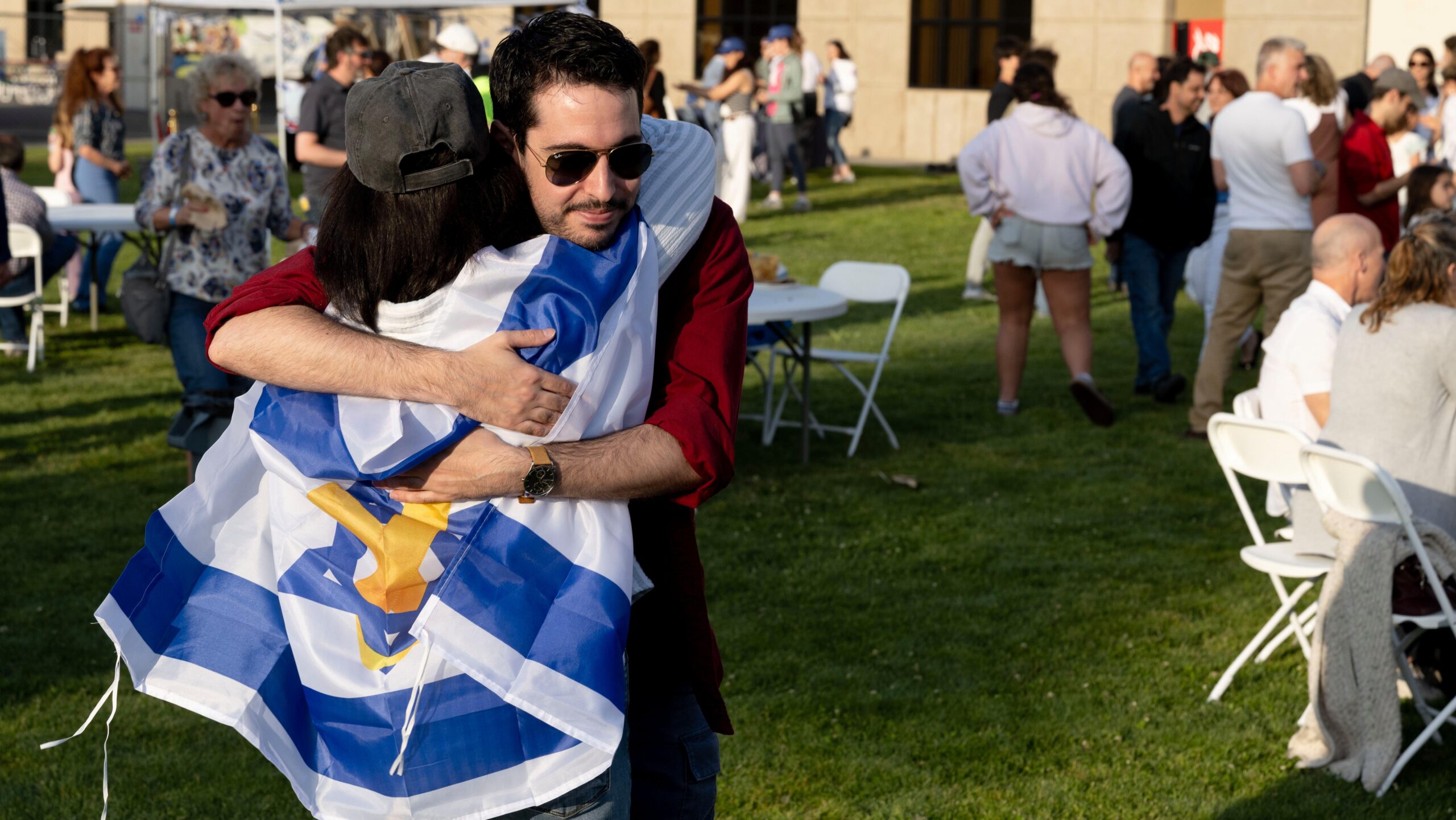Boaz Cogan (right) hugs Debbie Cogan during a Yom HaAtzmaut celebration at the Addison-Penzak JCC in Los Gatos, April 2025. (Aaron Levy-Wolins/J. Staff)