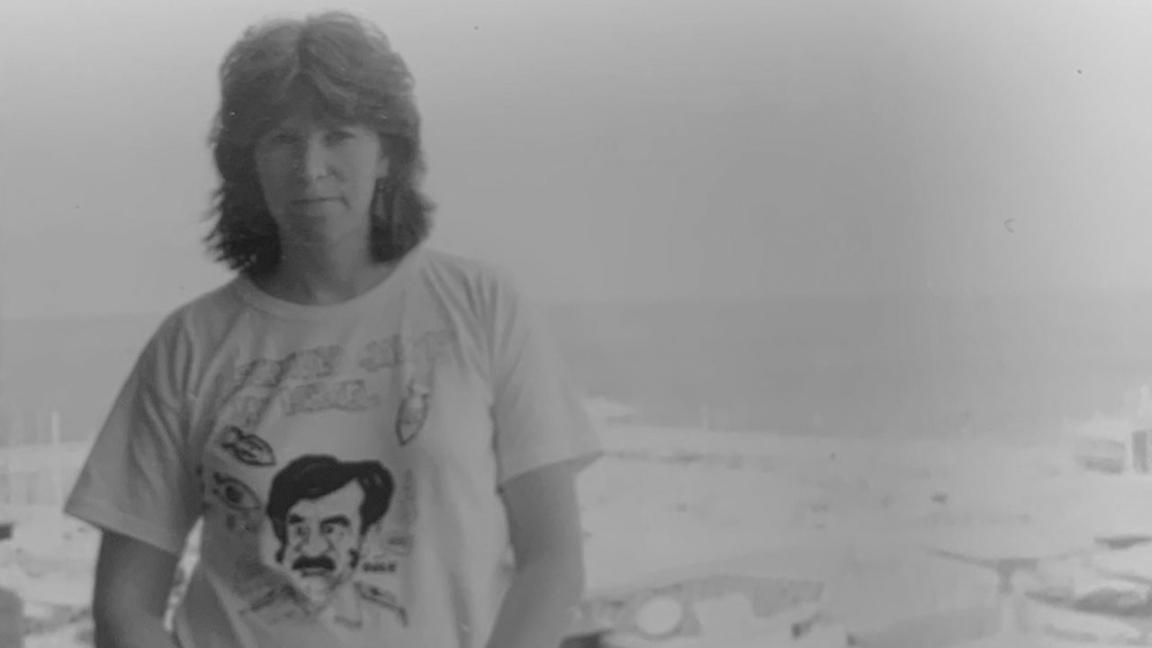 Sue Barnett in Tel Aviv in January of 1991, shortly after the start of the Gulf War. Her shirt has a caricature of Iraqi leader Saddam Hussein and reads "I survived Jan. 15 in Israel."