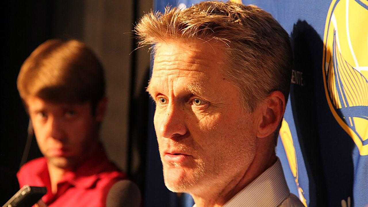 Steve Kerr talks to reporters following a game. (Cyrus Saatsaz via Wikimedia CC BY-SA 4.0)