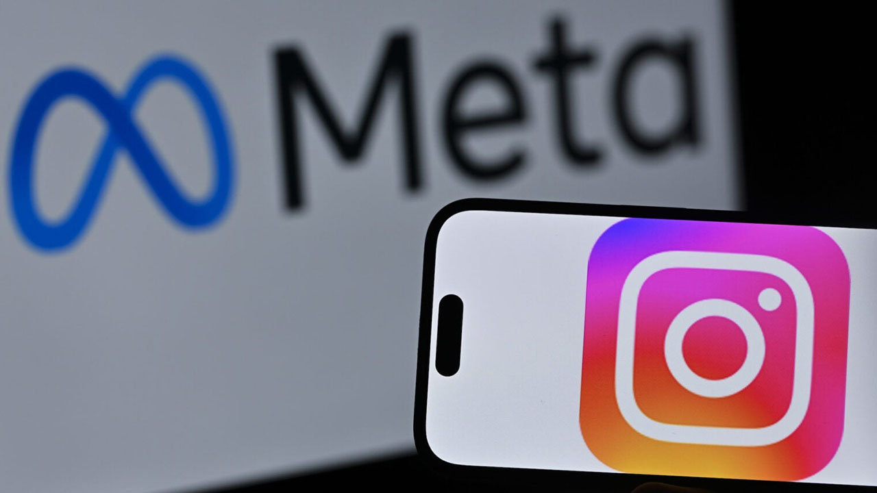 The Instagram logo is displayed on a mobile phone screen in front of a computer screen displaying Meta logo on April 10, 2026. (Ismail Kaplan/Anadolu via Getty Images)