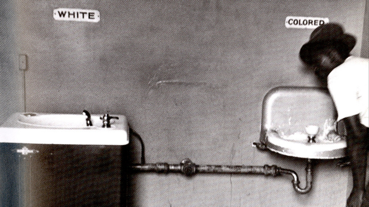 A man drinks from a segregated water fountain in Wilmington, North Carolina, in 1950. (Elliott Erwitt/National Museum of American History via Wikimedia/CC0 1.0)