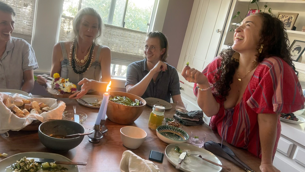 Mira Stern (right) mingles with her supper club guests at her Oakland home on May 19. (Alix Wall)