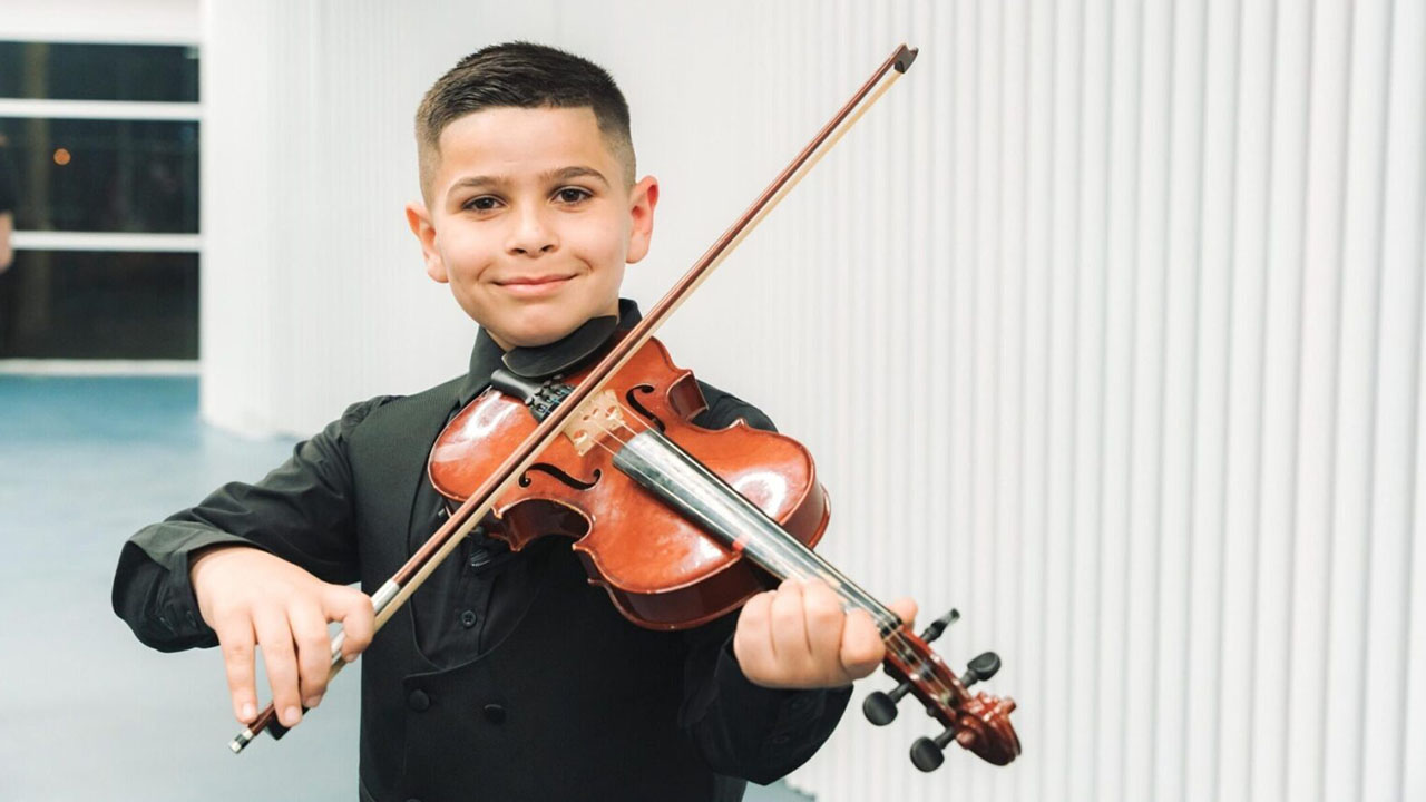 Youssef Sarhan, a 9-year-old violinist from Majd al-Krum, participates in The Jerusalem Orchestra East & West’s youth initiative. (Yaakov Buta)