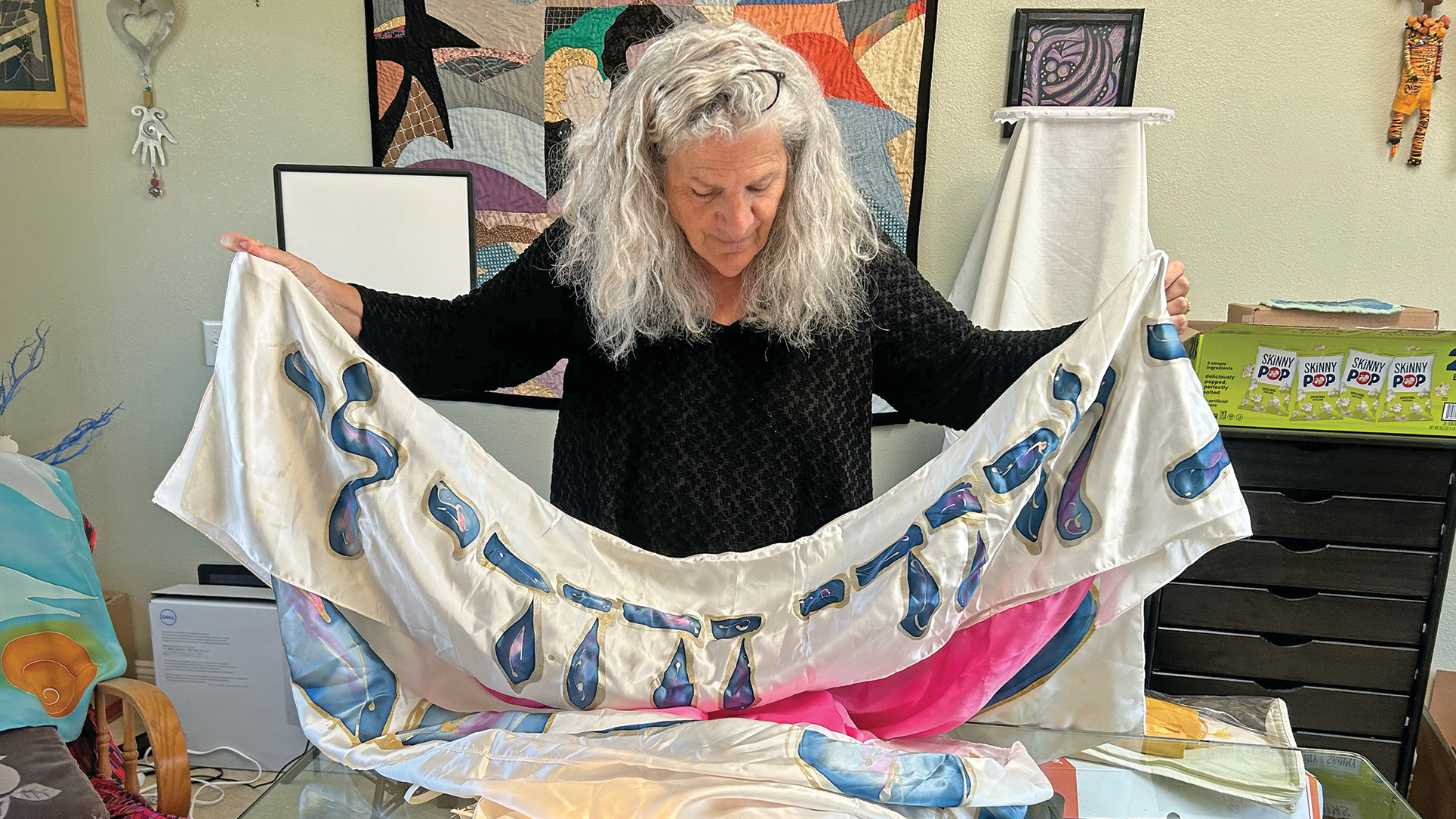 Nancy Katz unfolds one of the first chuppahs she made. (Alix Wall)