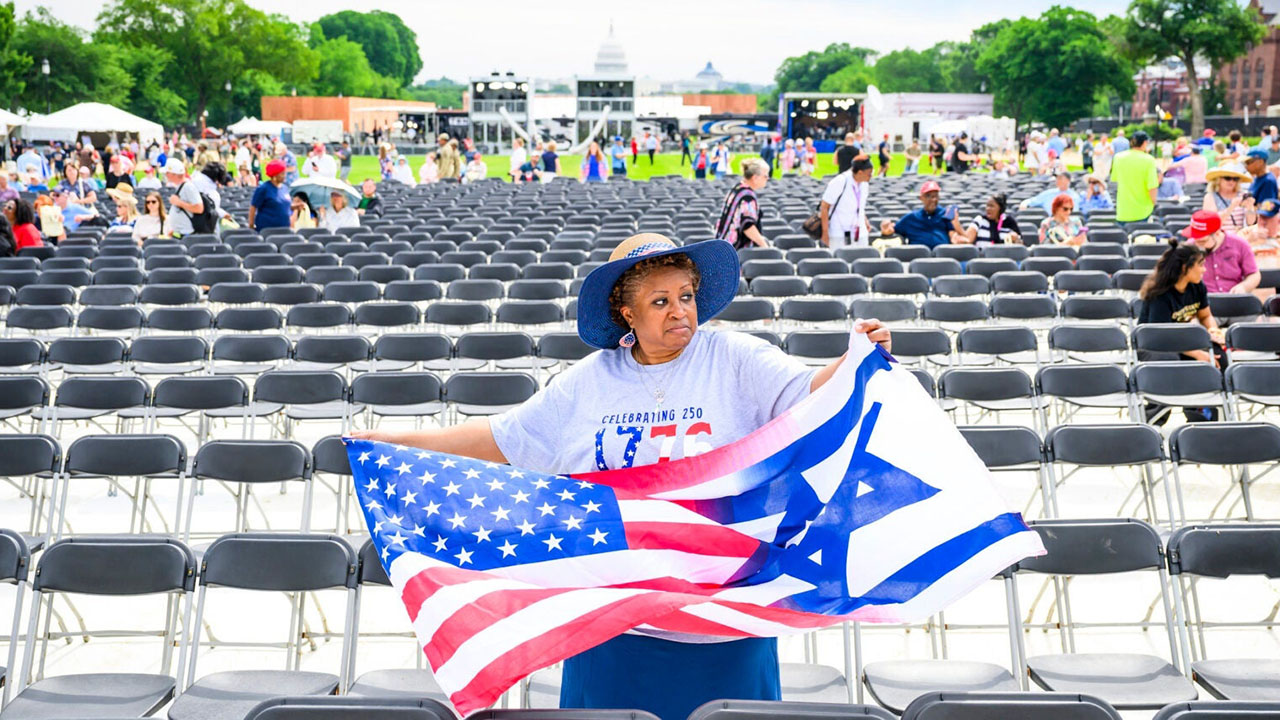 A woman holds a combination American-Israeli flags during Rededicate 250: A National Jubilee Of Prayer, Praise & Thanksgiving on the National Mall on May 17, 2026 in Washington, DC. (Pete Kiehart for The Washington Post via Getty Images)